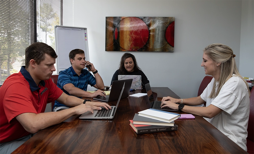 ppmg team at table in meeting